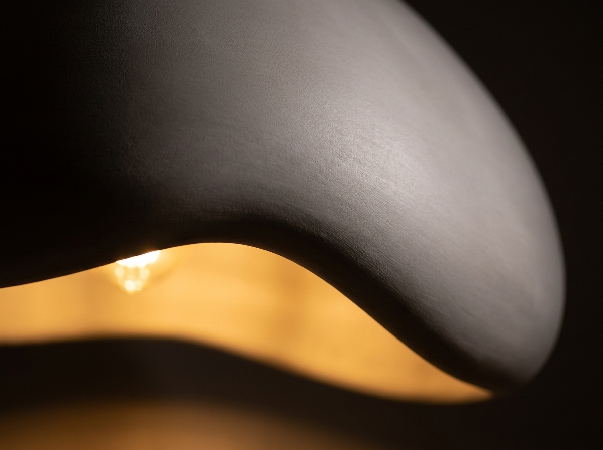 Close-up of the smooth resin pendant shade glowing with warm evening light
