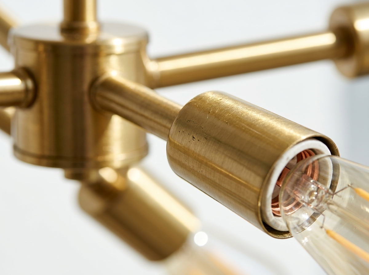 Close-up of the gold metal sputnik arms and exposed bulb sockets