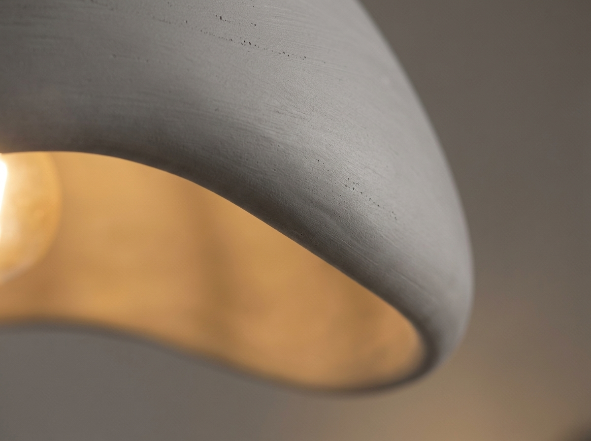 Close-up of the smooth resin material and warm diffused light of the pendant shade