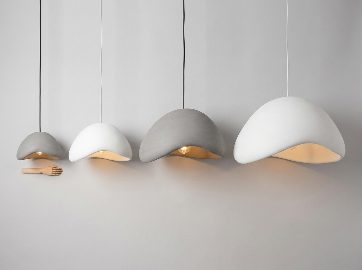 Four sizes of the resin pendant lamp shade shown side by side for scale, grey and white finishes